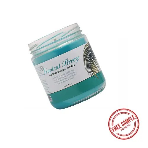 A Tropical Breeze Odor-Eliminating Candle with a stamp on side saying